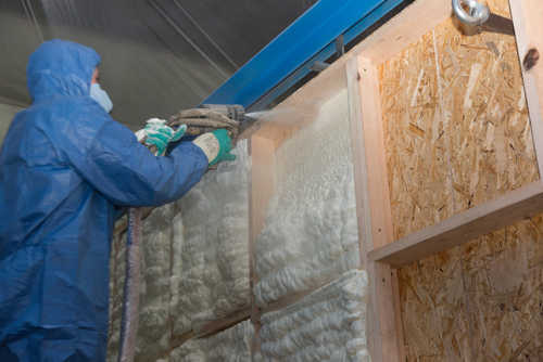 our team spraying an even layer of insulation to a wall
